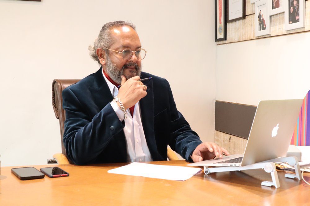 Col. Devrat Pagay (Retd.) at his desk, listening thoughtfully